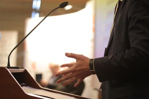 Photo: Presenter's open hands during a talk
