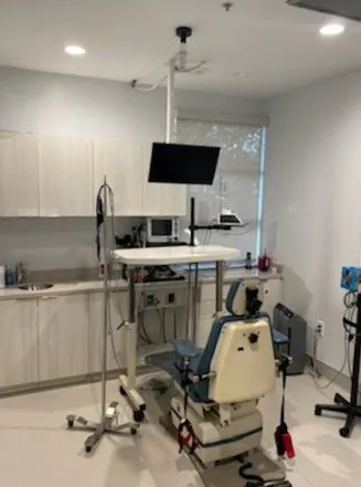 A dental op room with a chair and a television.